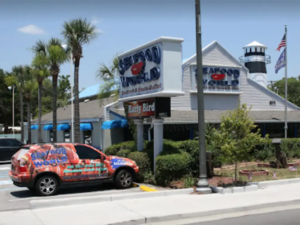 Seafood World restaurant exterior with branded car