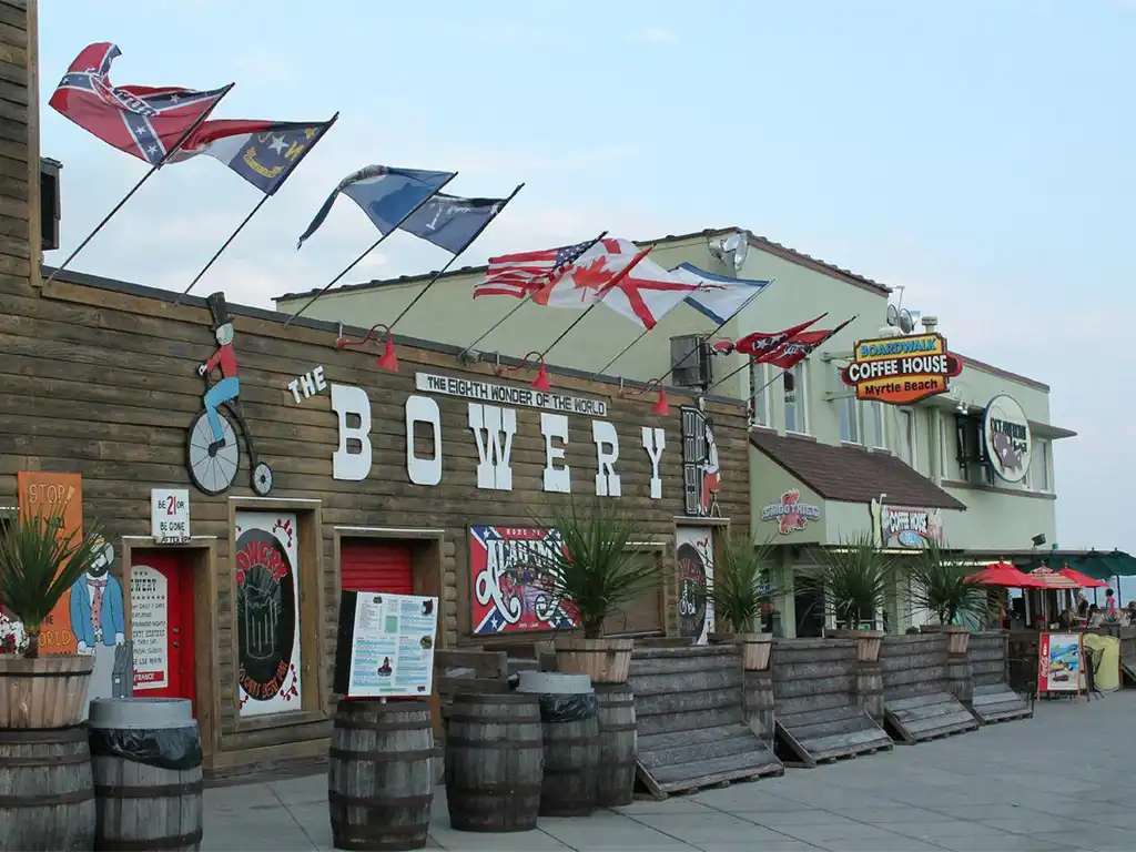 Exterior of The Bowery bar and grill with flags in Myrtle Beach