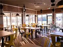 Indoor dining area with metal chairs and wooden tables
