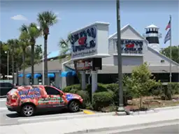 Seafood World restaurant exterior with branded car
