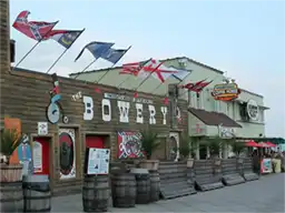Exterior of The Bowery bar and grill with flags in Myrtle Beach