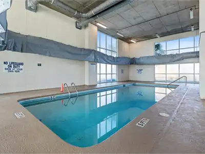 Bright indoor pool with spacious deck for year-round guest enjoyment
