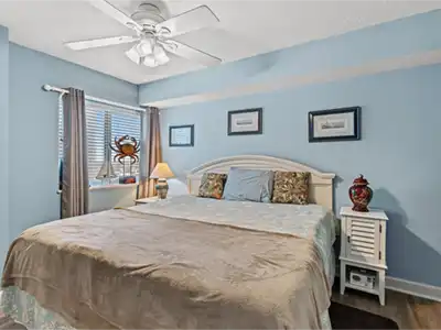 Bright coastal bedroom with king bed, natural light, and calming decor