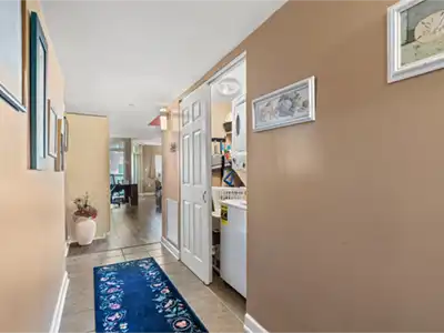 Bright hallway with in-unit laundry and warm, welcoming finishes