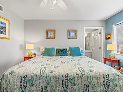 Coastal-inspired king bedroom with en suite bath and bright, relaxing decor